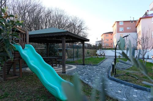 a playground with a slide and a gazebo at Şahin Tepesi Suite Otel in Trabzon
