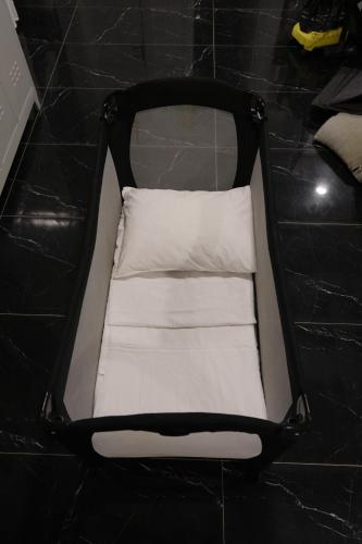 a black and white suitcase with a white pillow at Şahin Tepesi Suite Otel in Trabzon