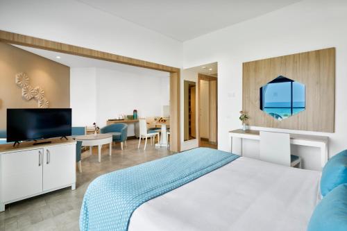 a hotel room with a bed and a living room at Nozha Beach Resort & Spa in Hammamet
