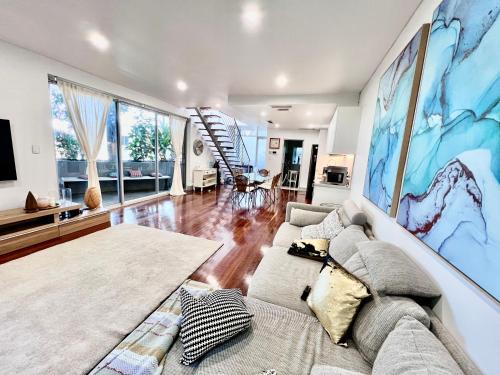 a living room with a couch and a table at Bondi Stylish Bedroom Close to the Beach in Sydney