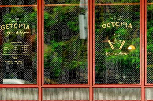 a pair of red glass doors in a store at Getcha Hostel in Taichung