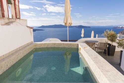 a swimming pool with a view of the ocean at Aperto Suites - Adults Only in Fira