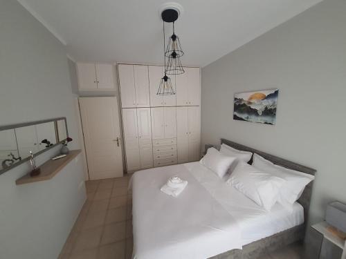 a bedroom with a white bed with white pillows at Gik Houses in Zakharo