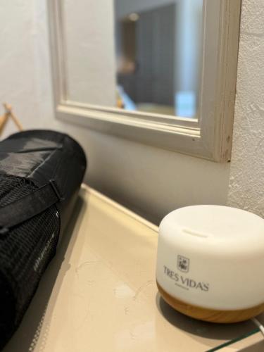 a hair dryer sitting on a table next to a window at Hotel Tres Vidas Acapulco in Barra Vieja