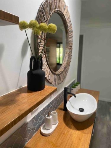 a bathroom with a sink and a mirror at Wagait Beach Sanctuary in Wagait Beach