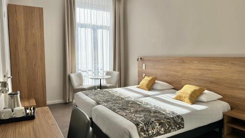 Un ou plusieurs lits dans un hébergement de l'établissement Hôtel Helvétique
