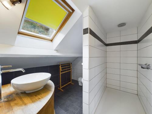 a bathroom with a white sink and a window at Chez Mémé in La Roche-en-Ardenne