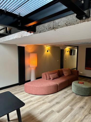 a living room with a couch and a table at Loft Apartment City Stay & Go Enschede in Enschede