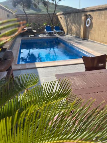 a swimming pool with blue water in a yard at 4 Bedroom Holiday Home with Private Pool in Għarb