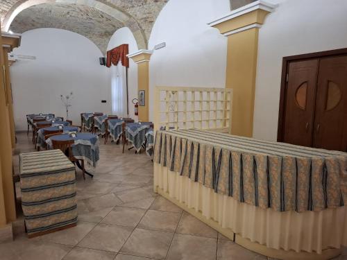 a room with tables and chairs in a building at Hotel 4 Mori in Cagliari
