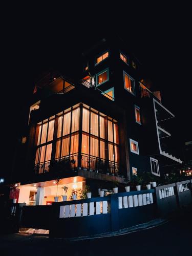 a tall building with many windows at night at Villa15 10bhk Private Villa With Pool And Scenic View in Porvorim