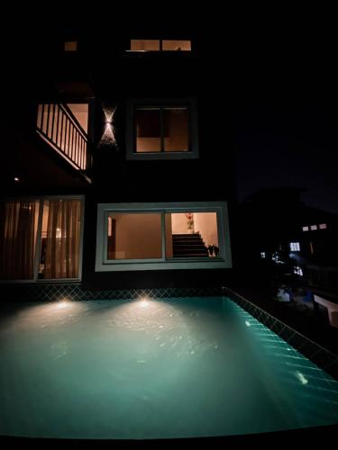 a house with a swimming pool in the dark at Villa15 10bhk Private Villa With Pool And Scenic View in Porvorim