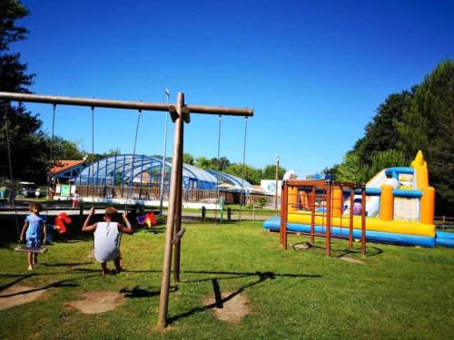 a group of children playing in a playground at Camping 4 étoiles - Piscine - eecaad in Aureilhan