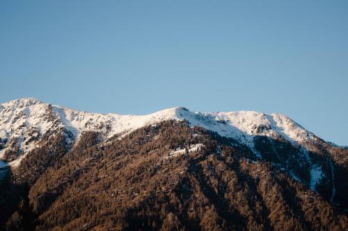 a mountain with snow on top of it at Armon Greenblu Hotel & Wellness in Folgarida