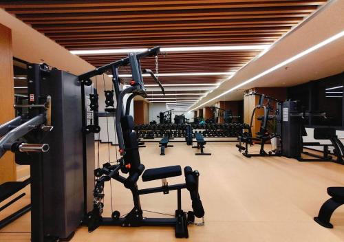 a gym with rows of treadmills and exercise equipment at 17FL LUX Studio Room Apartment, Great View in Phnom Penh