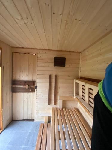 a large wooden sauna with a bench in it at +Authentic+ in Mariánské Lázně