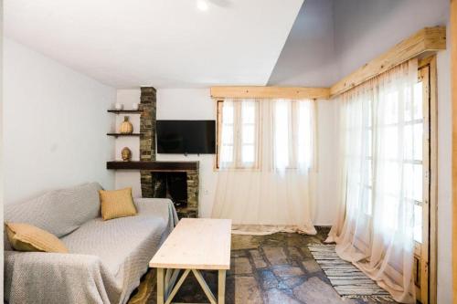 a living room with a couch and a fireplace at Reef in Afitos