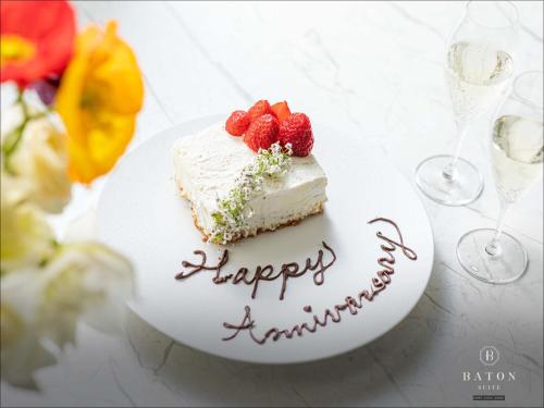 a piece of cake on a plate with strawberries on it at BATON SUITE Okinawa-kourijima in Nakijin