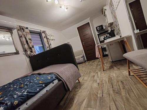 a bedroom with a bed and a desk in it at Silver Apartments in Bogács