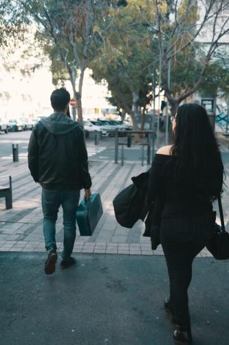 a man and a woman walking down the street at Ninna Palatin in Haifa