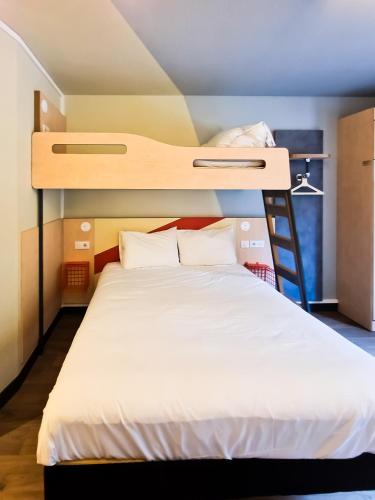 a bedroom with a bunk bed with a ladder at ibis Budget Lille Marcq En Baroeul in Marcq-en-Baroeul
