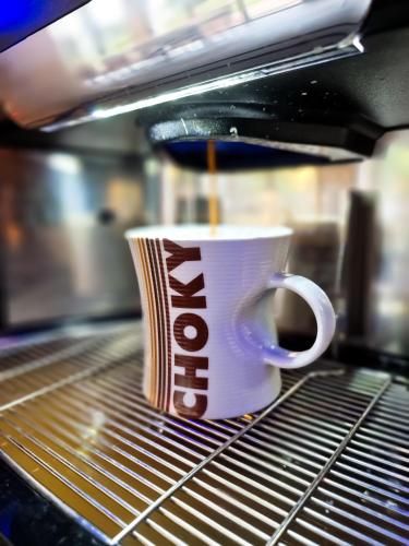 a coffee cup sitting on a drying rack in an oven at ibis Budget Lille Marcq En Baroeul in Marcq-en-Baroeul