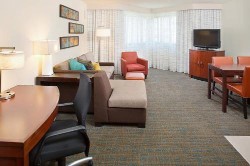 a living room with a couch and a tv at Residence Inn White Plains Westchester County in White Plains