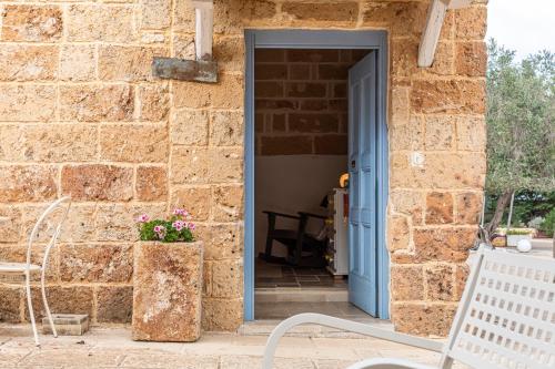 an open door to a stone building with a bench at Masseria La Tofala benessere & SPA in Copertino