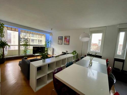 a living room with a couch and a table at BnGo I Le Spacieux I 12 personnes, 5 chambres, 2 salle de bain, parking privé, WC séparé, Wifi in Villeurbanne