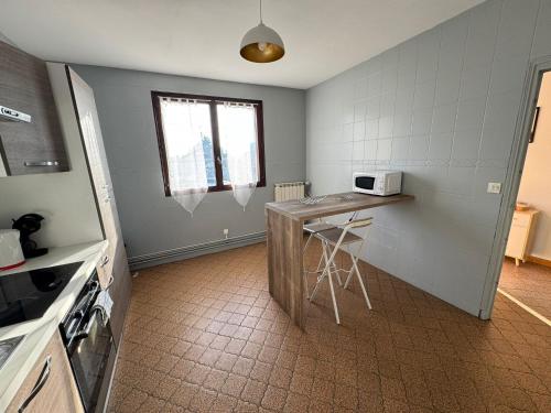 a kitchen with a counter and a table in it at 120m T4 terrasse et parking - Stade-Eurexpo-Lyon in Meyzieu