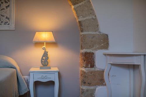 a lamp on a table in a room at Masseria La Tofala benessere & SPA in Copertino