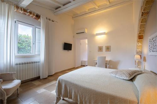 a bedroom with a large bed and a window at Masseria La Tofala benessere & SPA in Copertino