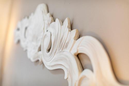 a close up of a white sculpture on a wall at Masseria La Tofala benessere & SPA in Copertino