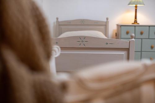 a person is looking at a bed in a bedroom at Masseria La Tofala benessere & SPA in Copertino
