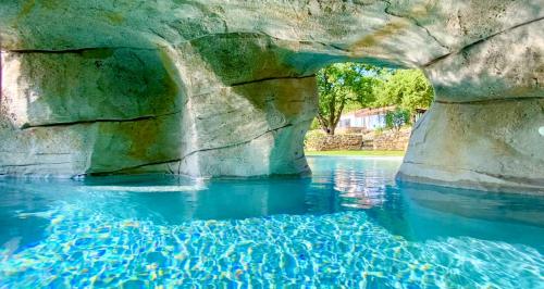 a pool of water with a large rock formation at Wild Boar Mountain, Luxury Escape & Stunning Views! in Bédarieux
