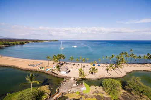 an aerial view of a beach with a boat in the water at Waikoloa Beach Marriott Resort & Spa in Waikoloa