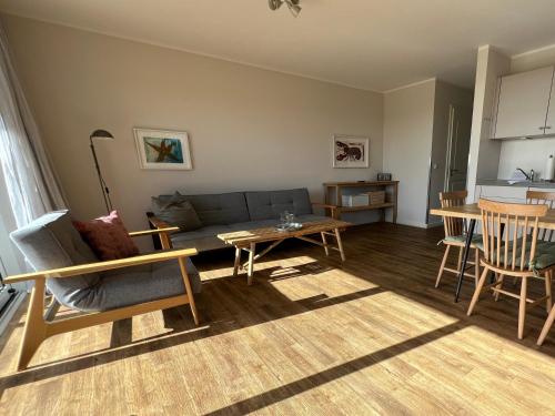 a living room with a couch and a table at Ostsee-Strandhaus-Holnis in Glücksburg