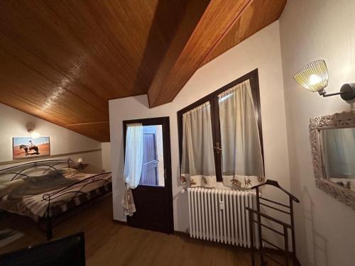 a bedroom with a bed and a window in a room at Tenuta I Ginepri in Ozzano dell Emilia