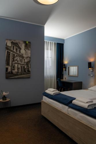 a hotel room with a bed and a desk at Hotel Grunt in Mladá Boleslav
