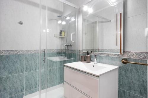 a bathroom with a sink and a shower with a mirror at Sorolla Rota free parking by Staycare in Rota