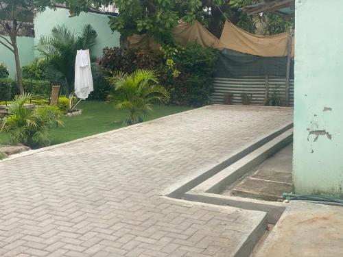 a brick patio with a tent in a garden at Aeropark Residencial (B&B) in Maputo