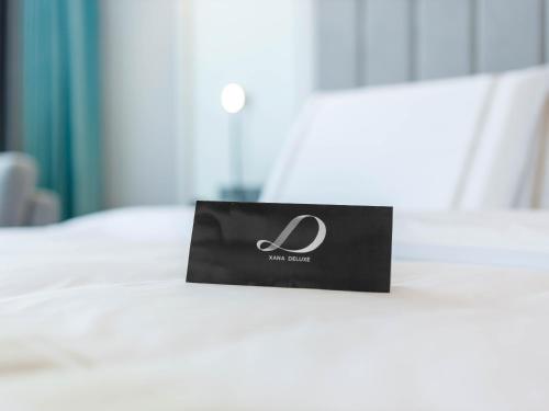 a bag sitting on top of a bed at Pazhou XANA Deluxe International Hotel Pazhou Convention and Exhibition Center Nanzhou Metro Station Branch - Free Shuttle Bus to Canton Fair Complex During Canton Fair Period in Guangzhou