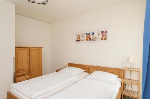 a bedroom with two beds with white sheets at Holiday at Alexanderplatz Apartments in Berlin