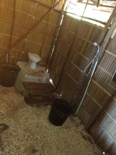 a bathroom with a toilet and two buckets at Yenaduak Guest House in Dokkor