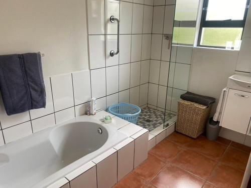 a bathroom with a large tub and a shower at lagoon value ! in Langebaan