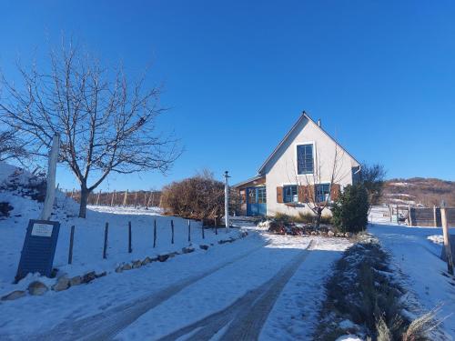 a house in the snow with a fence at Spaletta in Pécsely