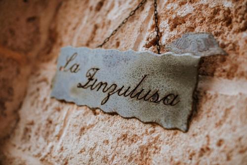 a sign that says la empidosa on a brick wall at Masseria La Tofala benessere & SPA in Copertino