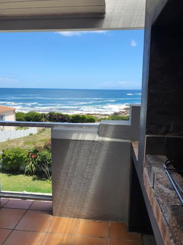 a balcony with a view of the ocean at Sunset Bliss - Gansbaai Seafront Accommodation in Gansbaai