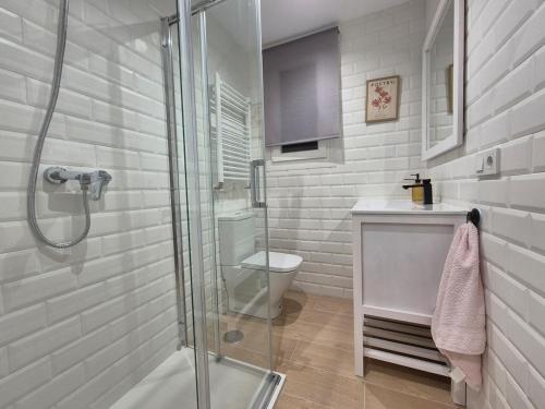 a white bathroom with a shower and a toilet at C01A07 Moderno apartamento con vistas in Santander