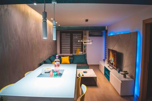 a living room with a white table and a couch at Luxury S&S panoramic city view apartment in Skopje